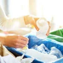 Woman-Putting-Empty-Plastic-Bottle-In-Recycling-Bin-In-The